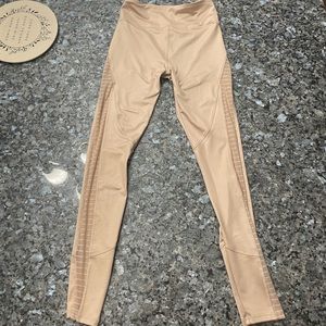 Tan leggings with mesh cuts down the entire leg